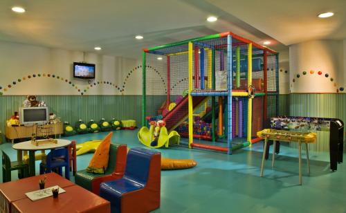 a childrens play room with a slide and a play area at Hotel Cascais Miragem Health & Spa in Cascais
