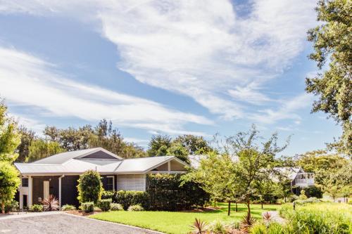 a home in the suburbs with a driveway at Bells at Killcare Boutique Hotel, Restaurant & Spa in Killcare