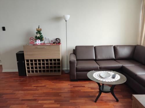 a living room with a couch and a table at Arena Costa Lima rooms Peru in Lima