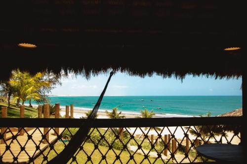 a view of the beach from a hammock on a beach at Collina Beach in Amontada