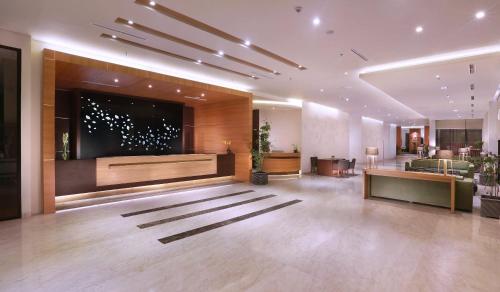 a lobby with a large screen in a building at Aston Bojonegoro City Hotel in Bojonegoro