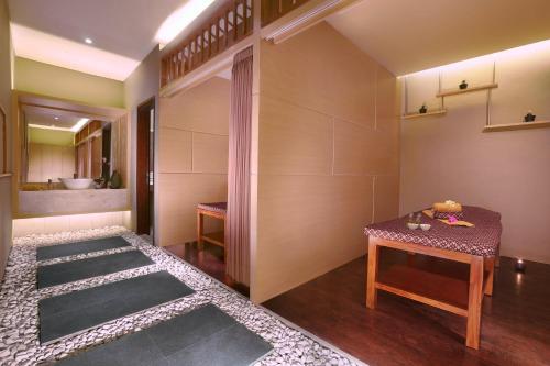 a bathroom with a table and a sink at Aston Bojonegoro City Hotel in Bojonegoro