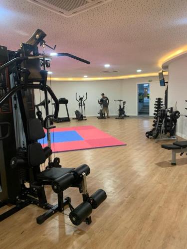 a gym with several exercise bikes and a man in a room at apartamento de frente para o mar com linda area de lazer in Arraial do Cabo