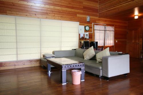a living room with a couch and a coffee table at Ji Ji Farm Homestay in Jiji