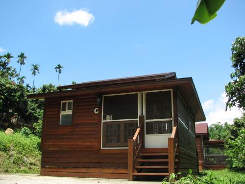 a small cabin with a large sliding glass door at Ji Ji Farm Homestay in Jiji