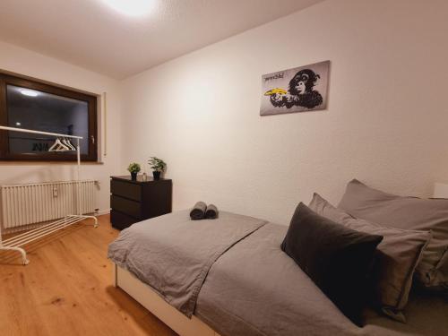 a bedroom with a bed and a window at Lifestyle-Appartment near BASF in Ludwigshafen in Ludwigshafen am Rhein