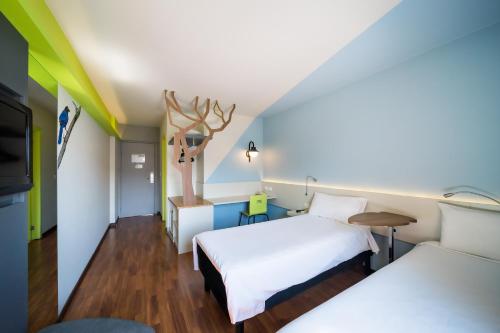 a hotel room with a bed and a table at ibis Styles Curitiba Centro Civico in Curitiba