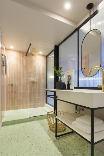 a bathroom with a shower and a sink and a mirror at L'Avventura Athens in Athens