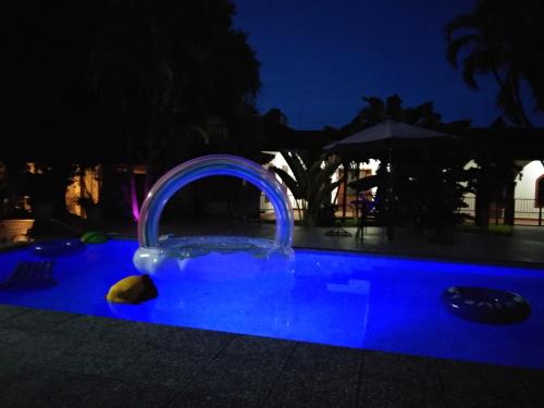 a swimming pool at night with a water feature at Hotel Henry Bacalar in Bacalar