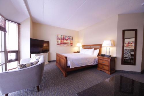 a hotel room with a bed and a television at The Water Tower Inn - BW Premier Collection in Sault Ste. Marie