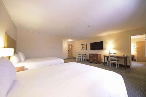 a hotel room with two beds and a flat screen tv at The Water Tower Inn - BW Premier Collection in Sault Ste. Marie