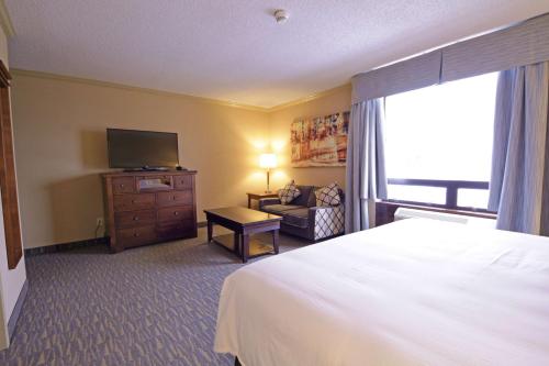 a hotel room with a bed and a television at The Water Tower Inn - BW Premier Collection in Sault Ste. Marie