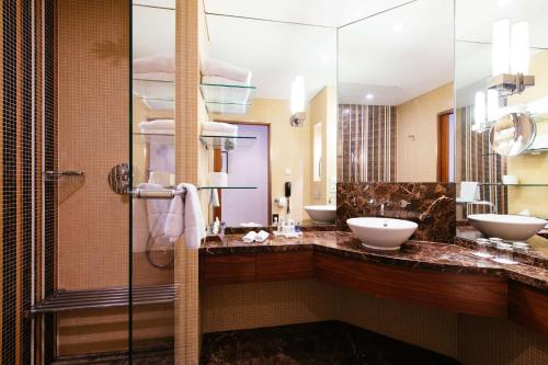 a bathroom with two sinks and a shower at Radisson Blu Style Hotel, Vienna in Vienna