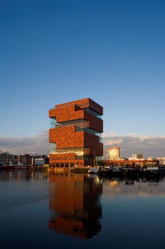 a building sitting on top of a body of water at Radisson Blu Hotel, Antwerp City Centre in Antwerp