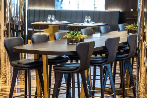 a row of tables and chairs in a restaurant at Radisson Blu Hotel, Antwerp City Centre in Antwerp