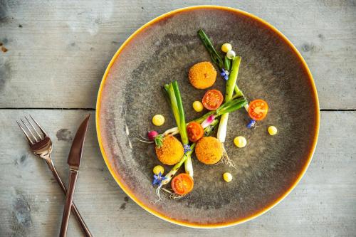 a plate of food with vegetables on a table at Radisson Blu Hotel, Antwerp City Centre in Antwerp