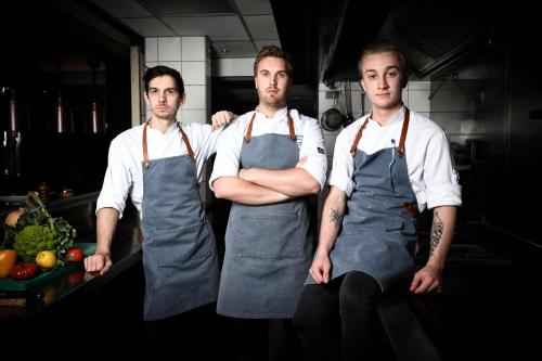 three men standing in a kitchen with their arms crossed at Radisson Blu Hotel, Antwerp City Centre in Antwerp