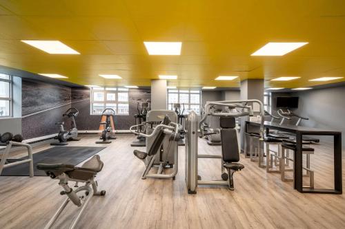 a gym with several tread machines and a table at Radisson Blu Hotel, Antwerp City Centre in Antwerp