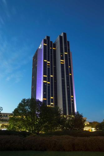 a tall building with purple lights on it at Radisson Blu Hotel, Hamburg in Hamburg