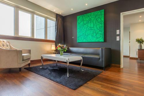 a living room with a couch and a table at Radisson Blu Hotel, Hamburg in Hamburg