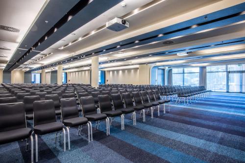 an empty room with chairs in a building at Radisson Blu Hotel, Hamburg in Hamburg