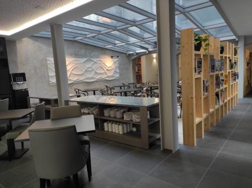 a restaurant with tables and chairs in a room at Flag Design Hotel in Viana do Castelo
