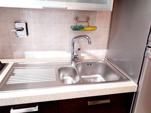 a stainless steel sink in a small kitchen at Old Center Station in Bologna