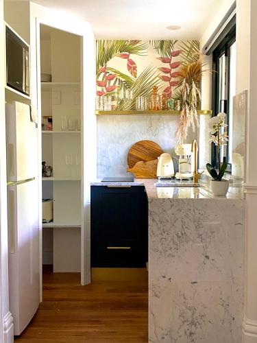a kitchen with a black and white counter top at Ultima- Unique elegance in Port Douglas in Port Douglas