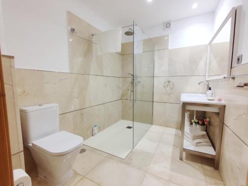 a bathroom with a shower and a toilet and a sink at Elle Ocean Villa Gran Canaria Heated pool Wifi in Amadores