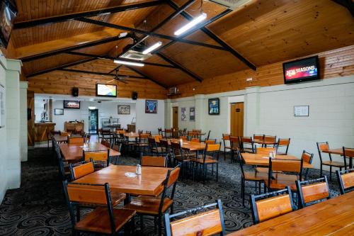 a dining room with wooden tables and chairs at Capella Hotel Motel in Capella