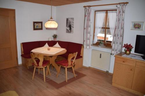 a dining room with a table and chairs and a television at Stoibhof Familie Klauser in Reit im Winkl