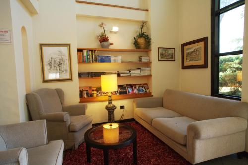 a living room with two couches and a table at Hotel Cristallo di La Rosetta Srl in Assisi