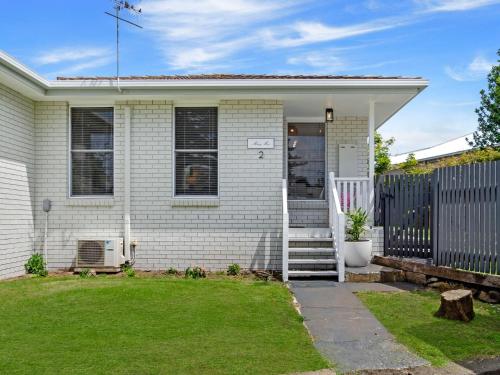 a house with a white door and a fence at MaryMae in Port Fairy