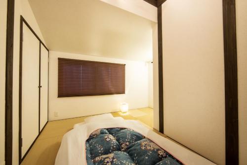 a bedroom with a bed and a large mirror at Rinn Kiyomizu Villa in Kyoto