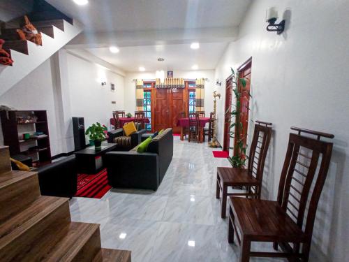 a large living room with a couch and chairs at Daffodils Inn in Adams Peak