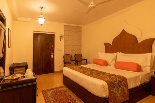 a bedroom with a large bed in a room at Amritara Suryauday Haveli in Varanasi