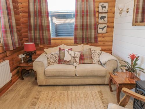 a living room with a couch with pillows on it at Ingram in Morpeth