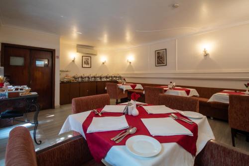 a restaurant with two tables with red and white table cloth at Amritara Suryauday Haveli in Varanasi