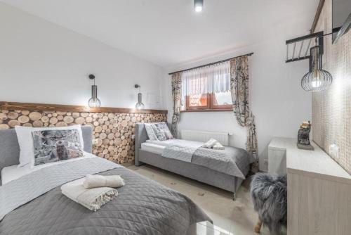 a bedroom with a bed and a dog in it at Biały Jeleń z basenem i jacuzzi in Białka Tatrzanska