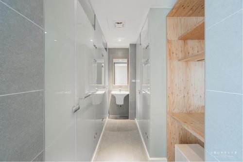a white bathroom with a sink and a toilet at 山鄰山林青年文旅 forest 3030 hostel in Yuli