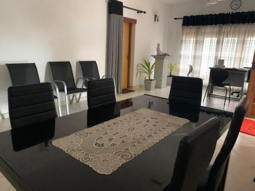 a dining room with a table and chairs at Sobha Holiday Home in Anuradhapura