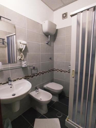 a bathroom with a sink and a toilet at Hotel Parco Dei Principi in Scalea
