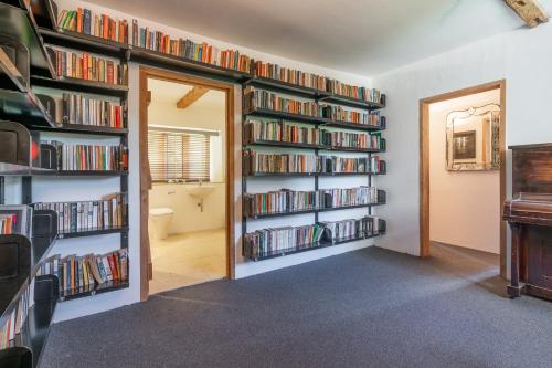 a room filled with book shelves filled with books at The Barracks in Northleach