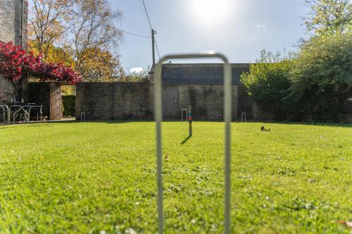 a dog sitting in the grass in a field at The Barracks in Northleach