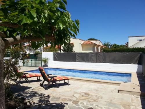 a patio with two chairs and a swimming pool at Laila in Riumar