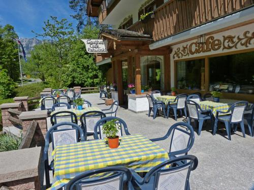 a group of tables and chairs in front of a restaurant at Gasthof Rehwinkl in Ramsau