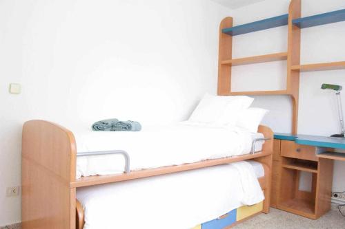 a bedroom with two bunk beds and a desk at Apartamento AVENIDA DO MAR in A Coruña