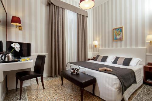 a hotel room with a bed and a desk at Hotel Nord Nuova Roma in Rome