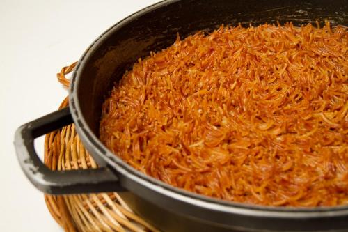 a pan filled with shredded carrots sitting on a basket at Hotel Antiga in Calafell