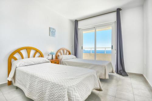 Postel nebo postele na pokoji v ubytování Homeincalpe Apolo XVI 2-11-52
